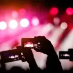silhouette-hands-using-smartphones-take-pictures-videos-live-music-show[1]